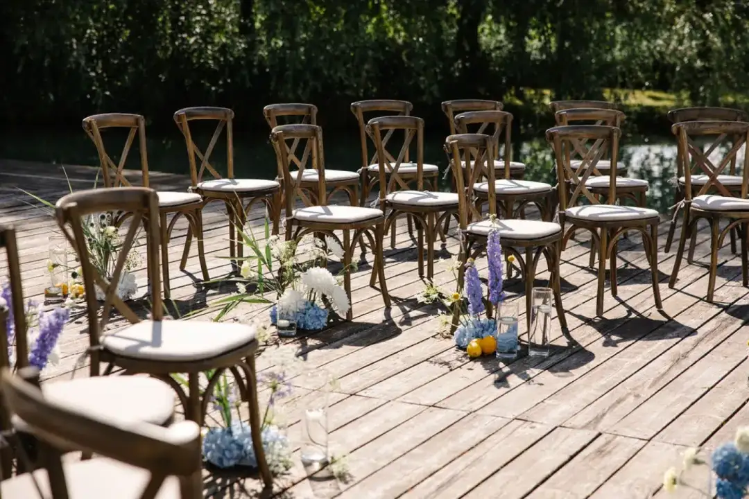Rows of wooden chairs set up on a deck